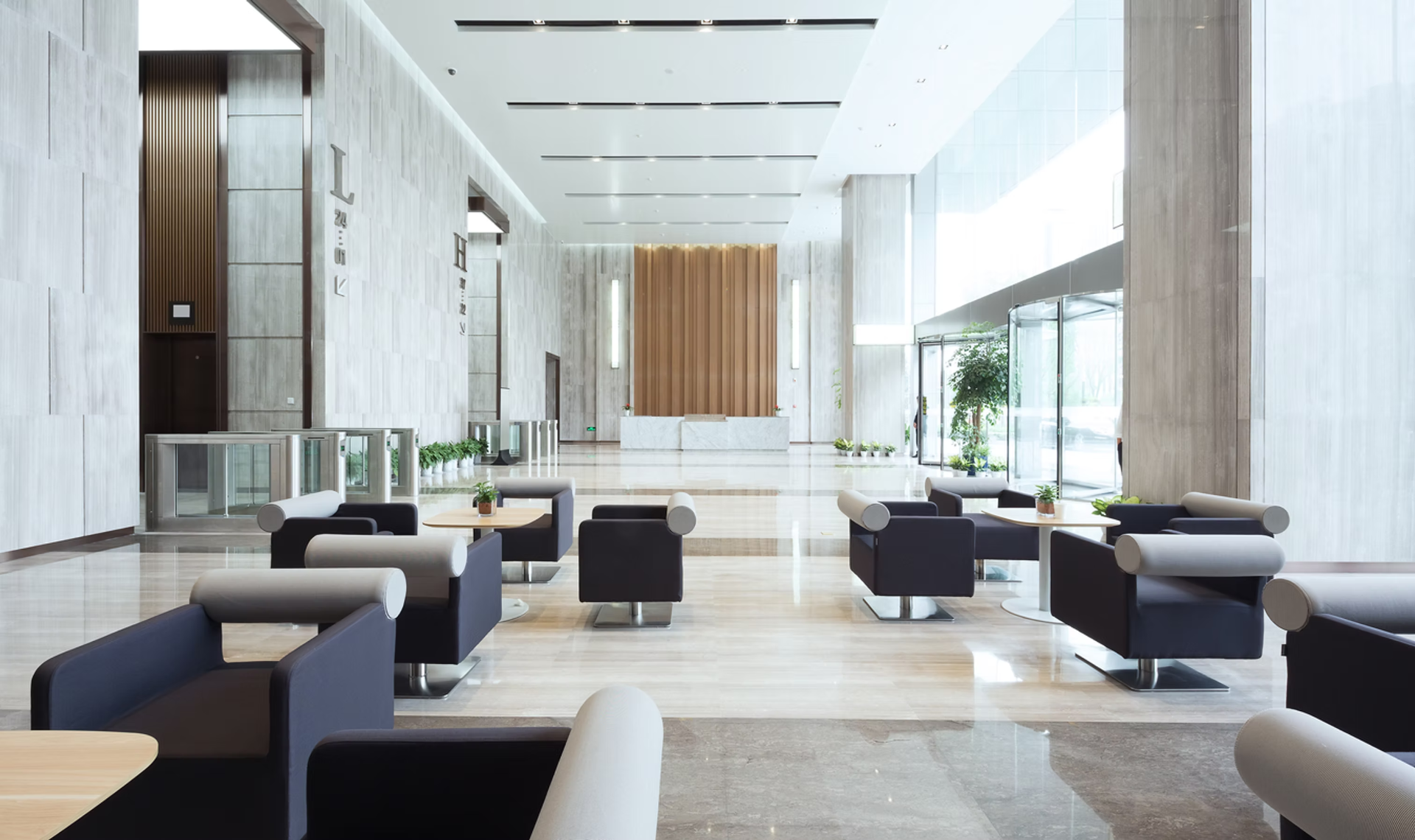 Modern commercial lobby with polished stone floors and contemporary lounge seating